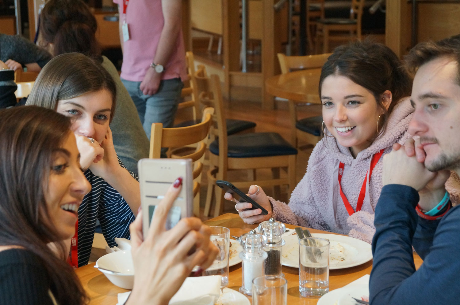 A group of young adults enjoy lunch together at one of The Brain Tumour Charity's Young Adult Meet Ups for people aged 16-30 who are affected by a brain tumour diagnosis.