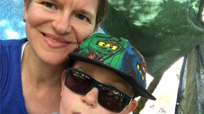 Rowan, an eight year old boy who was diagnosed with a low grade brain tumour in 2011, poses for a photo with his mum, Kerry. Rowan looks incredibly cool in his sunglasses and Lego Ninjago baseball cap.