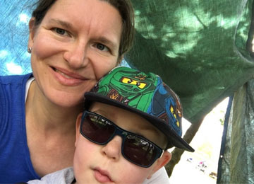 Rowan, an eight year old boy who was diagnosed with a low grade brain tumour in 2011, poses for a photo with his mum, Kerry. Rowan looks incredibly cool in his sunglasses and Lego Ninjago baseball cap.